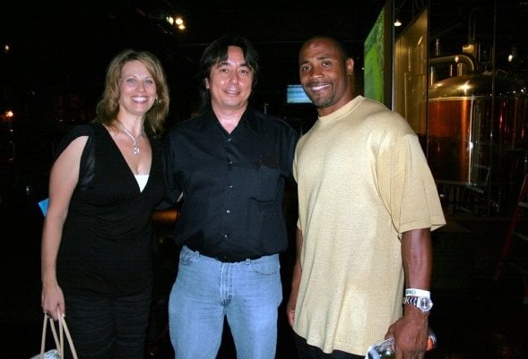 2 men and woman posing for a photo